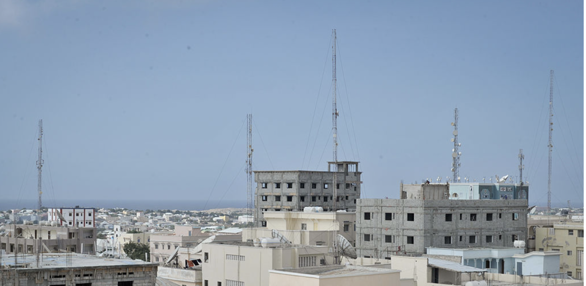 Photo of tall buildings in Mogadishu with cell phone towers rising from their roofs